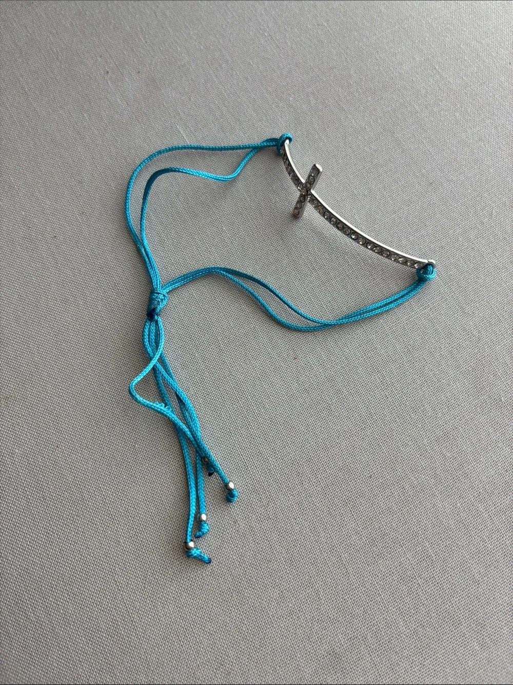 Silver Cross Pendant Bracelet with Turquoise Cord